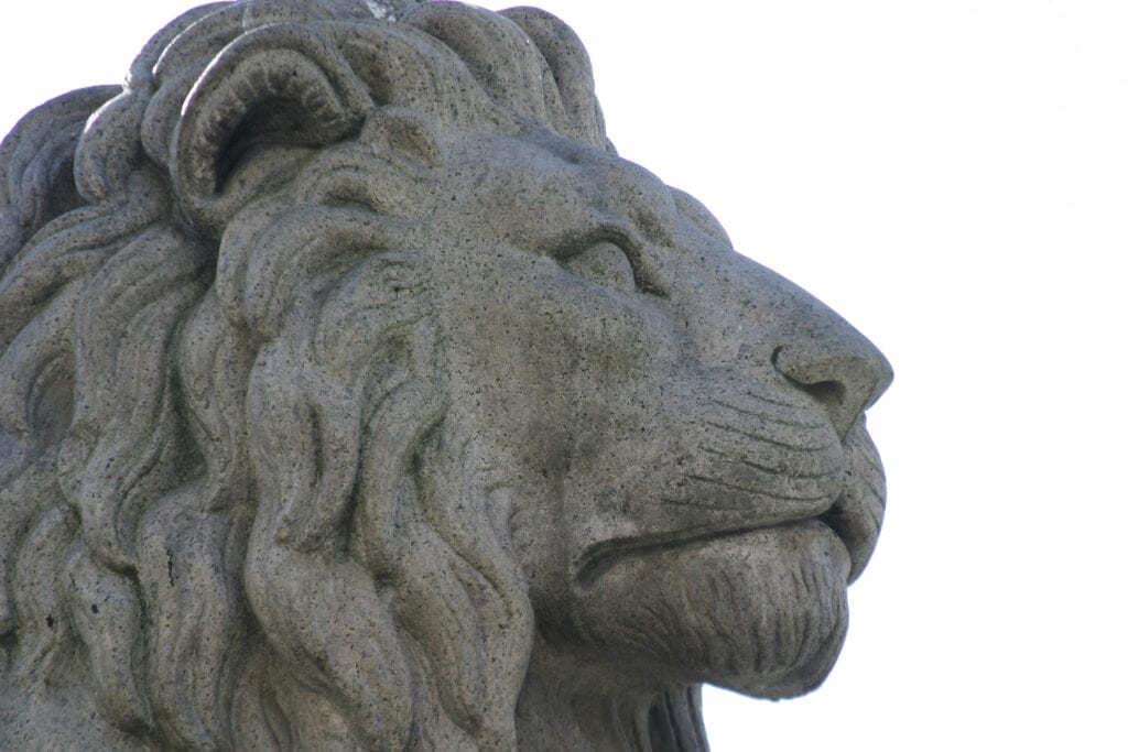 A close up image of a lion statue infront of stortinget, Oslo, parliment building.
